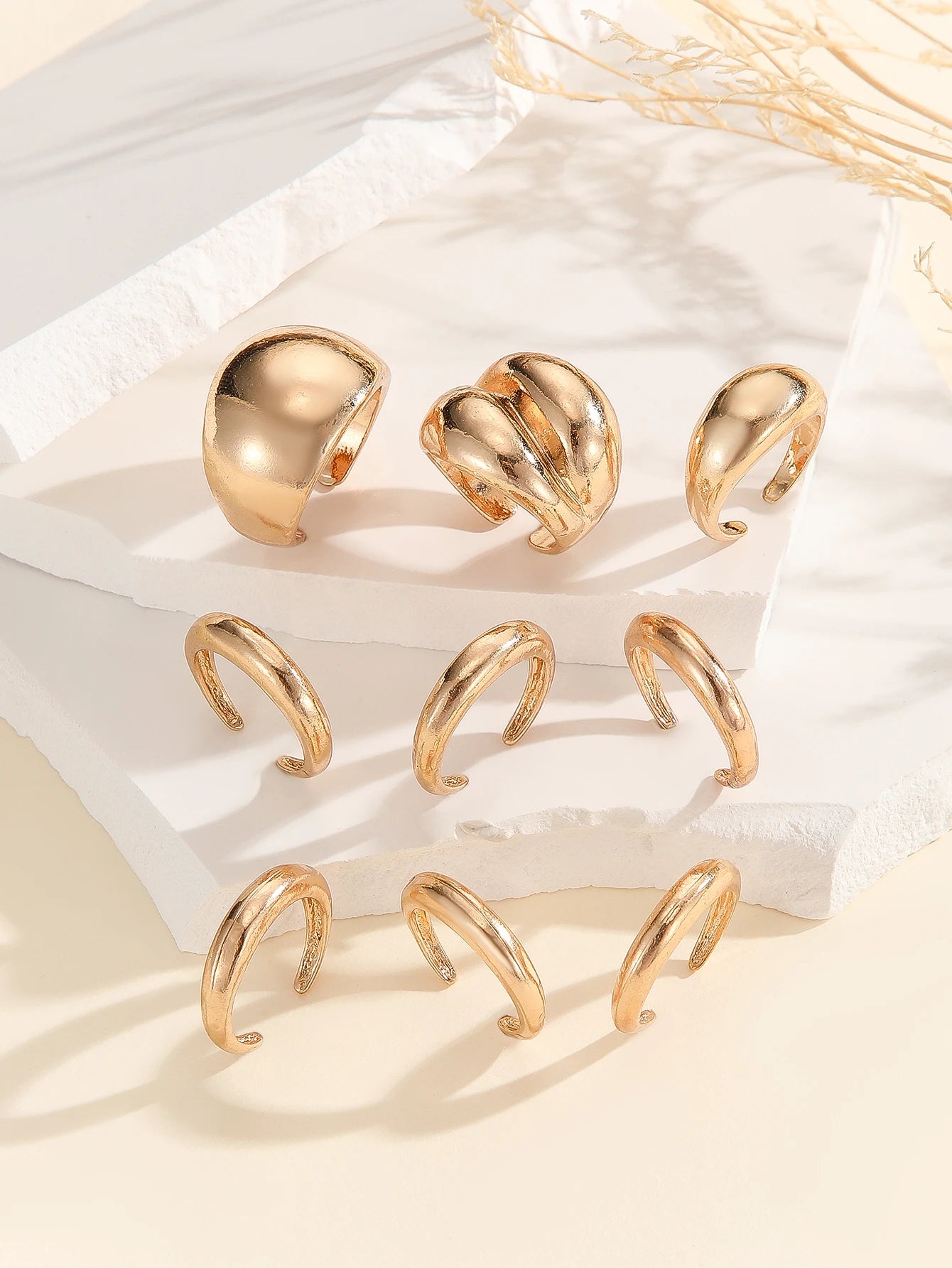 A set of nine uniquely designed, asymmetrical double-layered arc-shaped rings, perfect for women to wear daily or at parties.