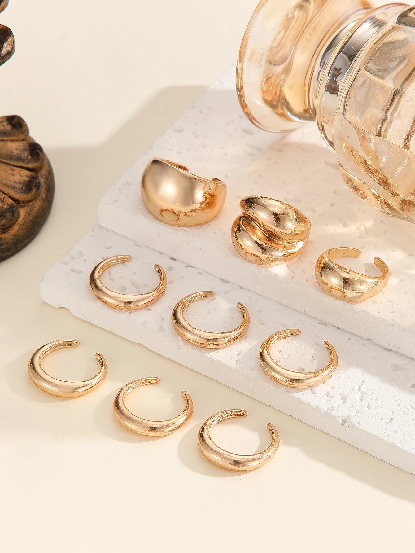 A set of nine uniquely designed, asymmetrical double-layered arc-shaped rings, perfect for women to wear daily or at parties.