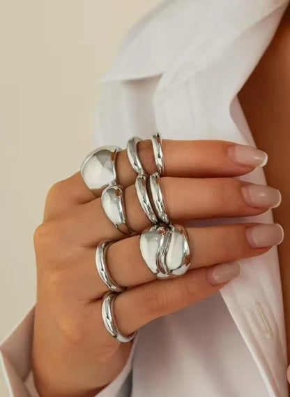 A set of nine uniquely designed, asymmetrical double-layered arc-shaped rings, perfect for women to wear daily or at parties.
